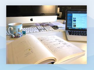 Photo of sketch book and computer screen